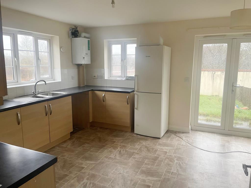 Lot: 73 - SUBSTANTIAL SEMI-DETACHED HOUSE - Kitchen with fitted units and double doors leading to rear garden